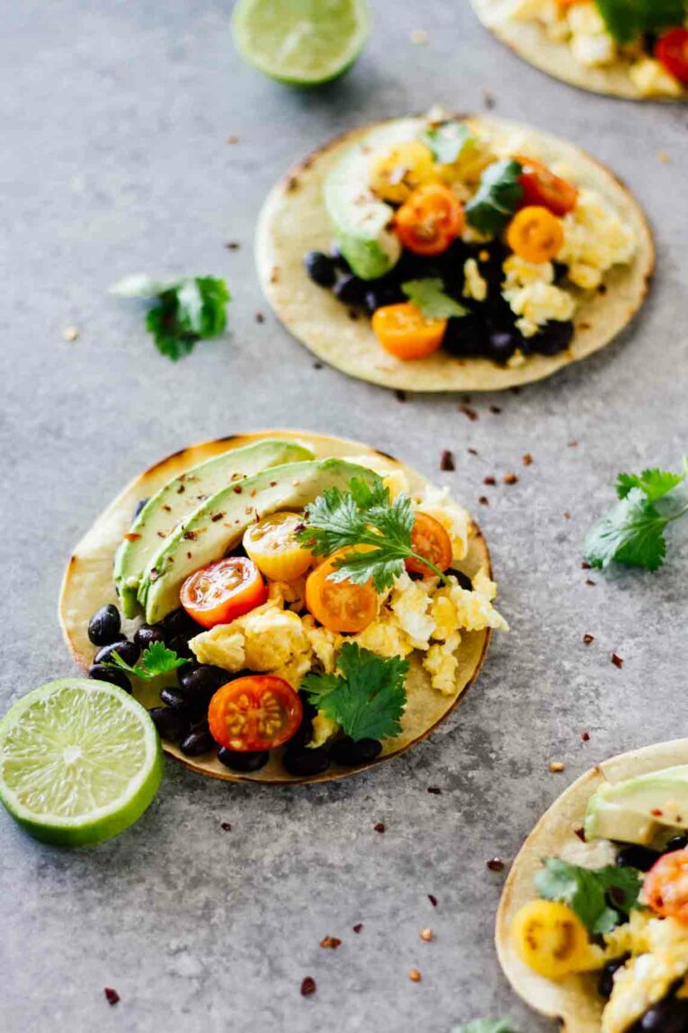 A close up of healthy breakfast tacos and lime wedges