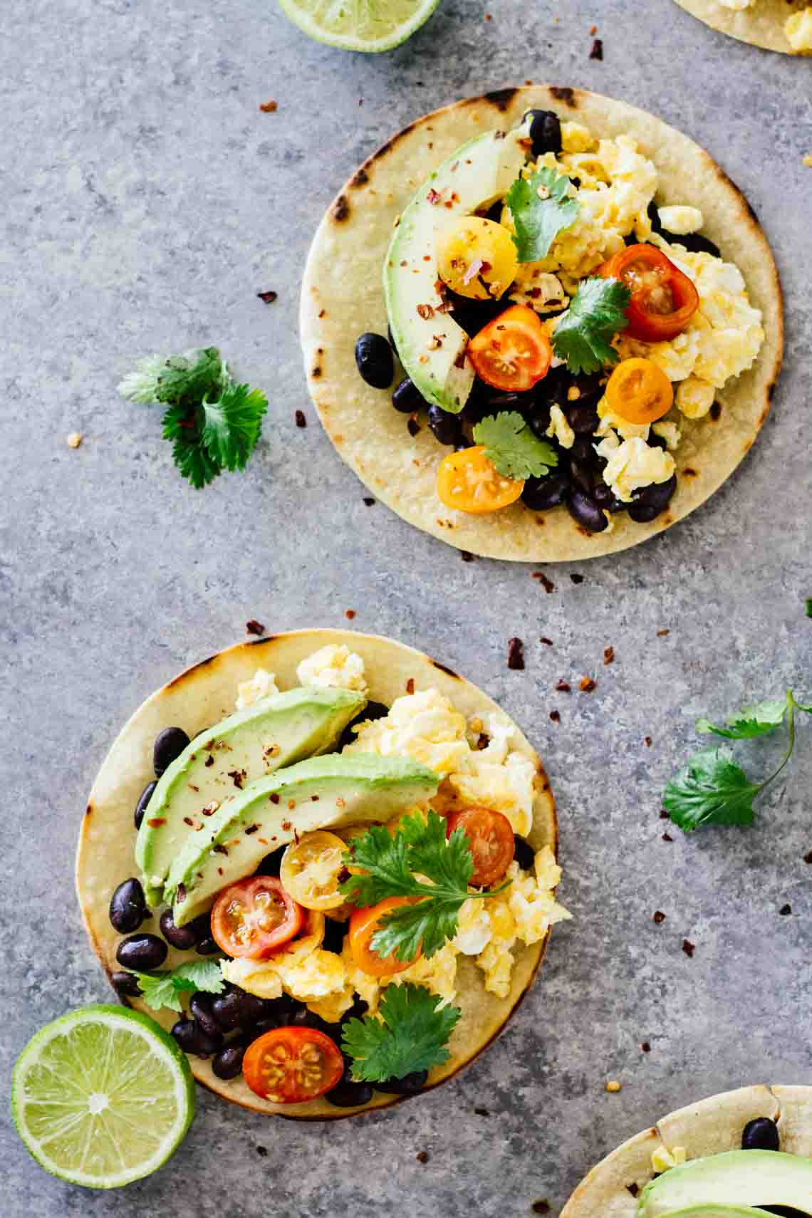 Overhead shot of The BEST Healthy Breakfast Tacos on a grey surface. 