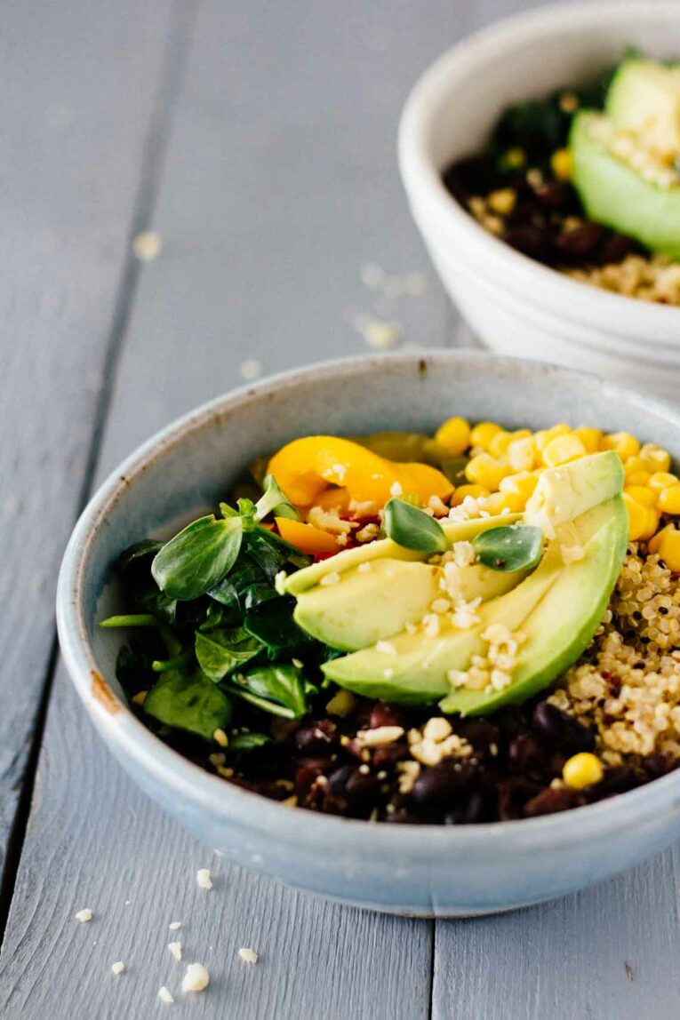  Black Bean Quinoa Bowls in a grey bowl on a wooden surface