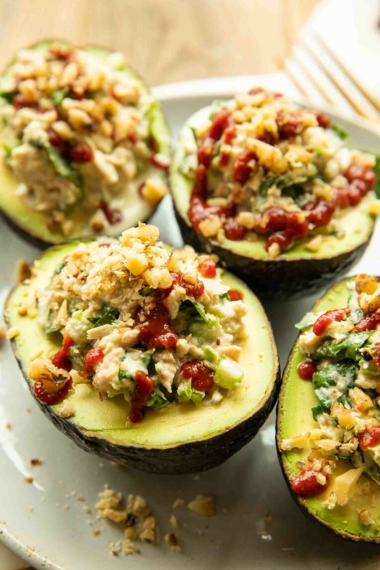 Healthy Sriracha Tuna Stuffed Avocado sitting on a countertop.