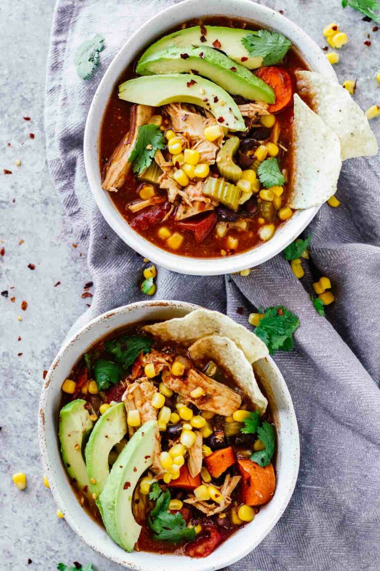 Overhead shot of Slow Cooker Skinny Chicken Tortilla Soup served in two white bowls