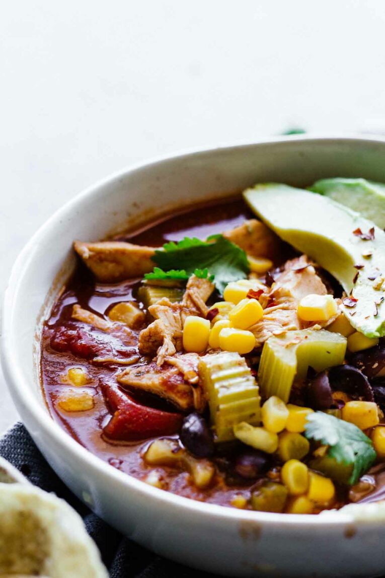Close up of Slow Cooker Skinny Chicken Tortilla Soup in a white bowl