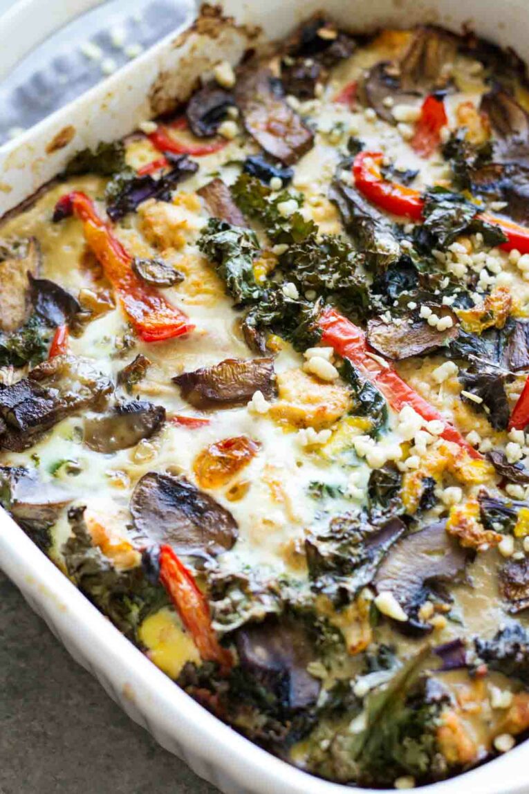 A close up of a breakfast casserole in a white dish