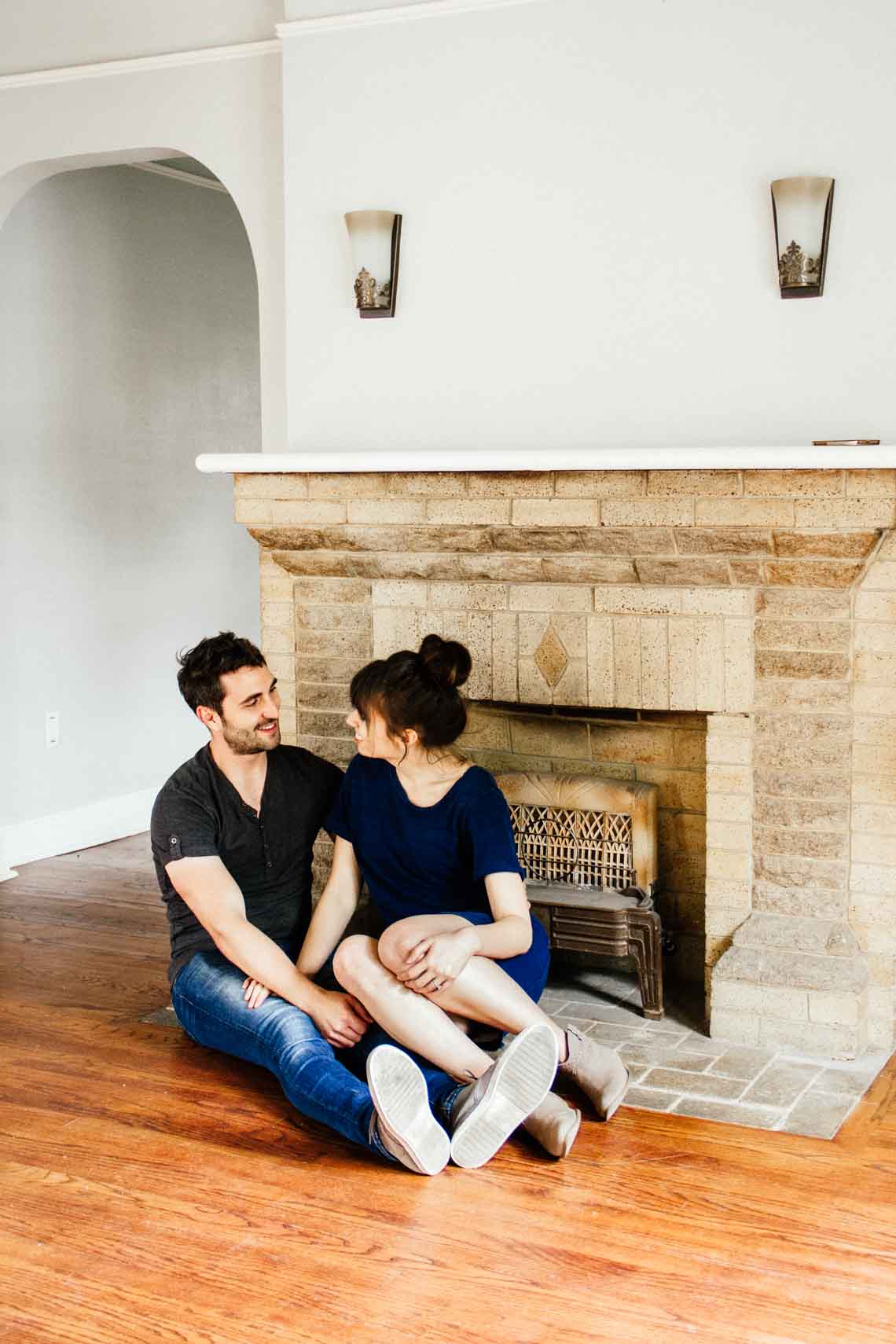 Couple sitting on the floor in their new home.