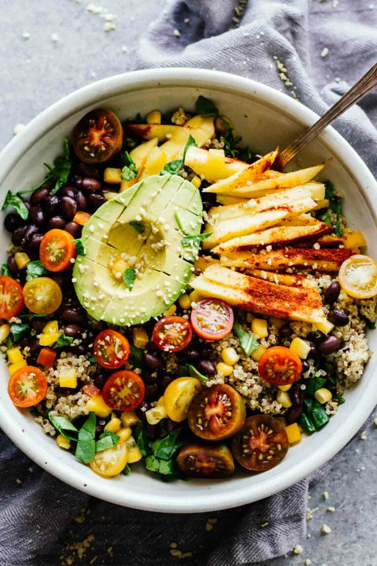 Chili Mango Zesty Quinoa Salad in a grey bowl with a fork.