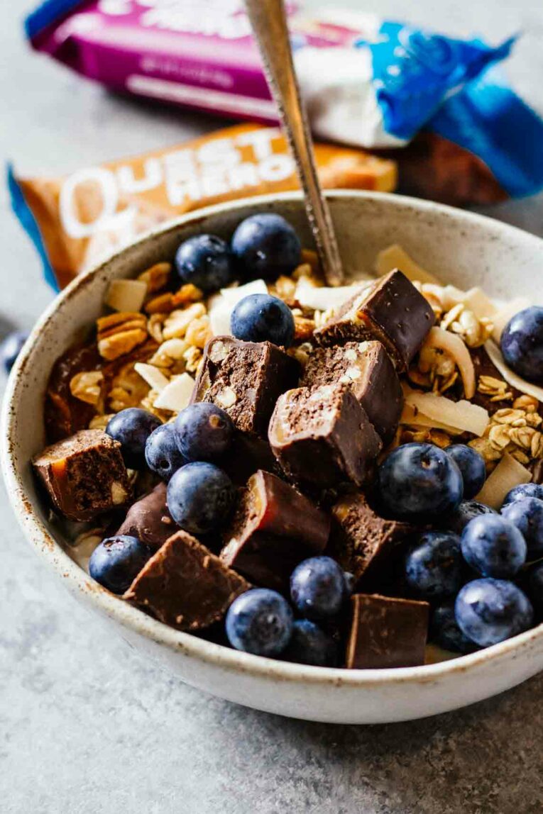 Chocolate Caramel Pecan Yogurt Bowls for an easy and delicious breakfast! Loaded with protein and great for taking on-the-go! #yogurtbowls #breakfastbowls #pecans A close up of Loaded protein yogurt bowls