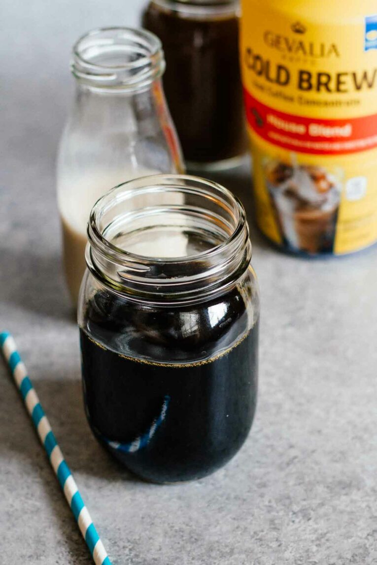 The most delicious Vanilla Coconut Cold Brew Coffee made with simple ingredients and taste better than your coffee shop favorite. You won't believe how easy it is to make cold brew at home, perfect for summer! #coldbrewcoffee #coldcoffee #coffeedrink Easy Vanilla Coconut Cold Brew Coffee Ingredients sitting on a counter