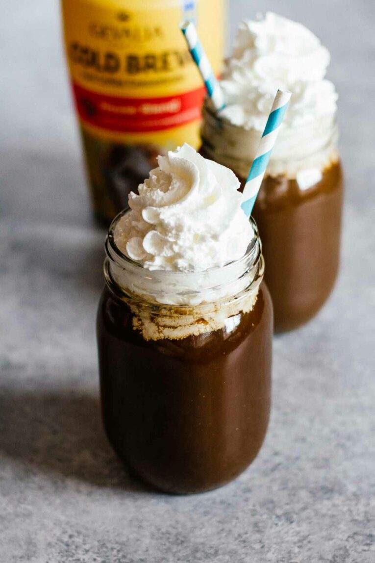 The most delicious Vanilla Coconut Cold Brew Coffee made with simple ingredients and taste better than your coffee shop favorite. You won't believe how easy it is to make cold brew at home, perfect for summer! #coldbrewcoffee #coldcoffee #coffeedrink Cold Brew Coffee with whipped cream in two mason jars