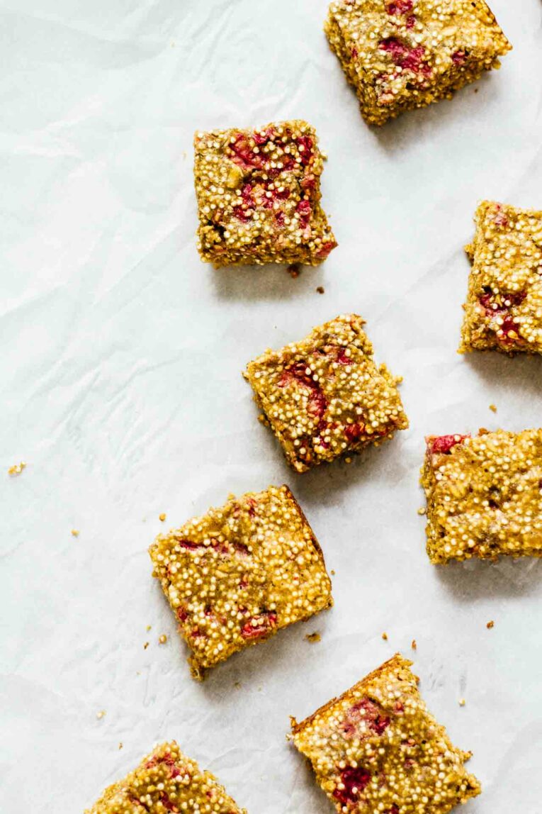 Overhead shot of  Raspberry Breakfast Quinoa Bars arranged on parchment paper