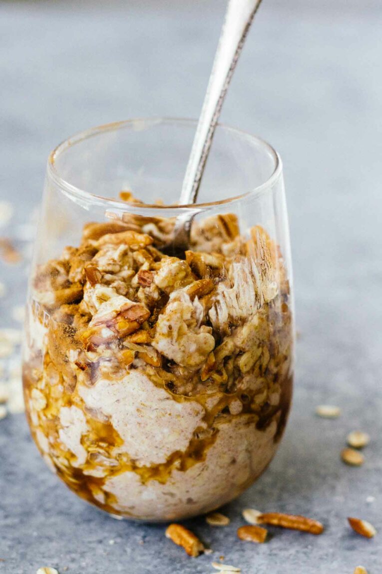 Maple Cinnamon Pecan Overnight Oats in a glass with a spoon