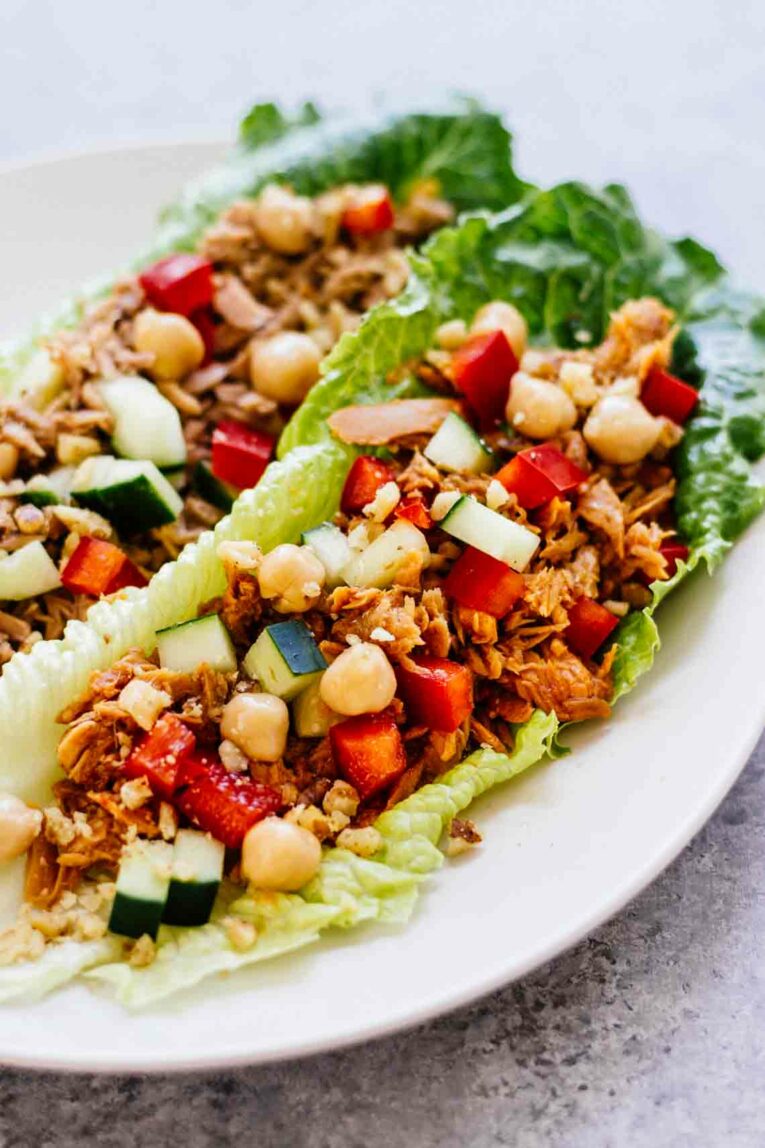 Romaine lettuce leaves filled with tuna, zucchini, red peppers, and chickpeas.
