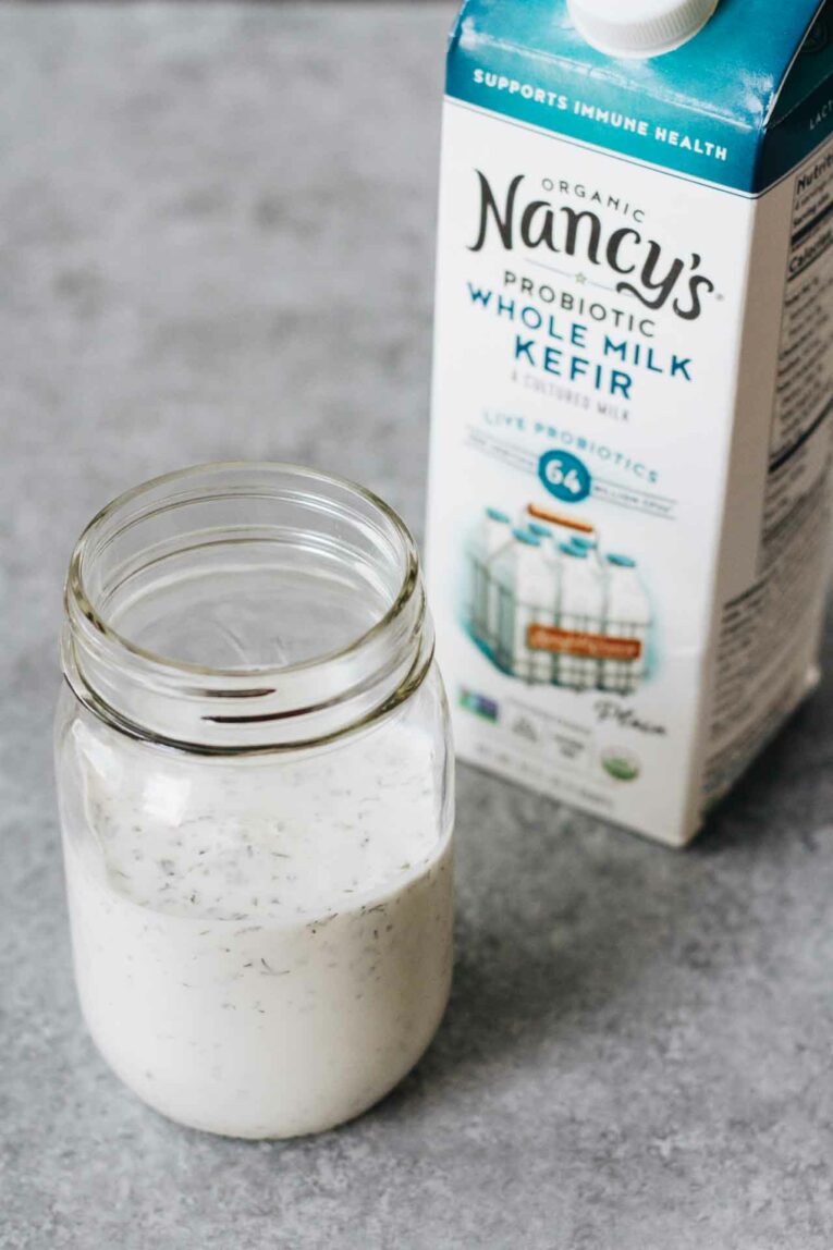 10-Minute Healthy Ranch Dressing in a mason jar with a container of Kefir
