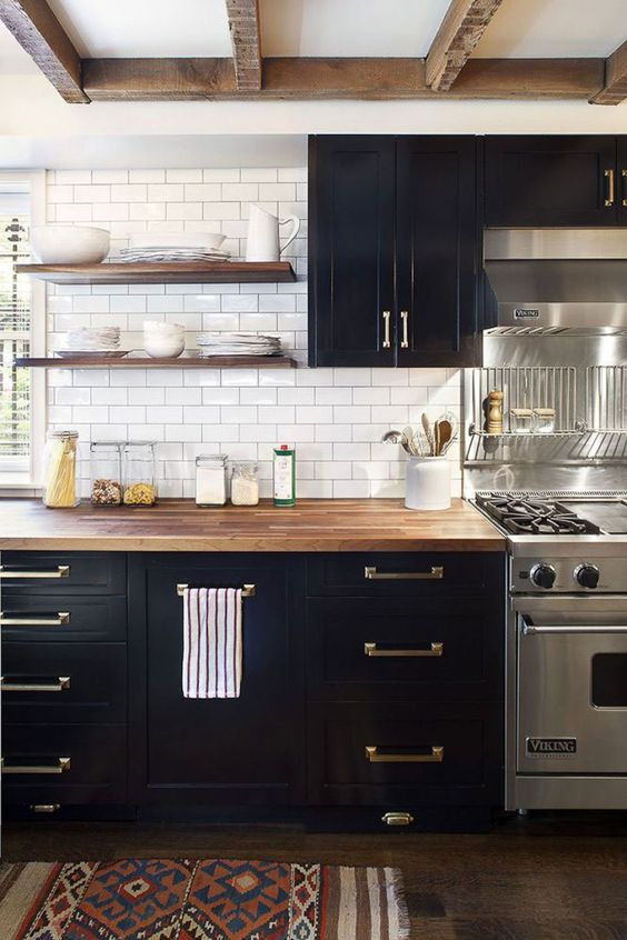 Image of kitchen with black cabinets, subway tile for backsplash and shelves