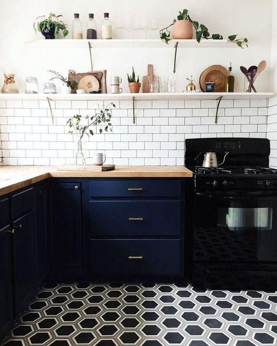 image of kitchen with open shelves, subway tile, and dark bottom cabinets