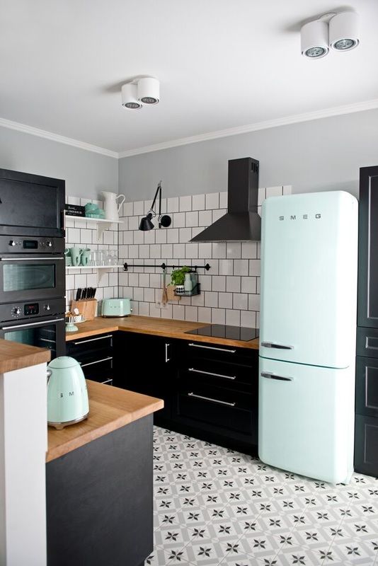 image of kitchen with dark cabinets and appliances with subway tile