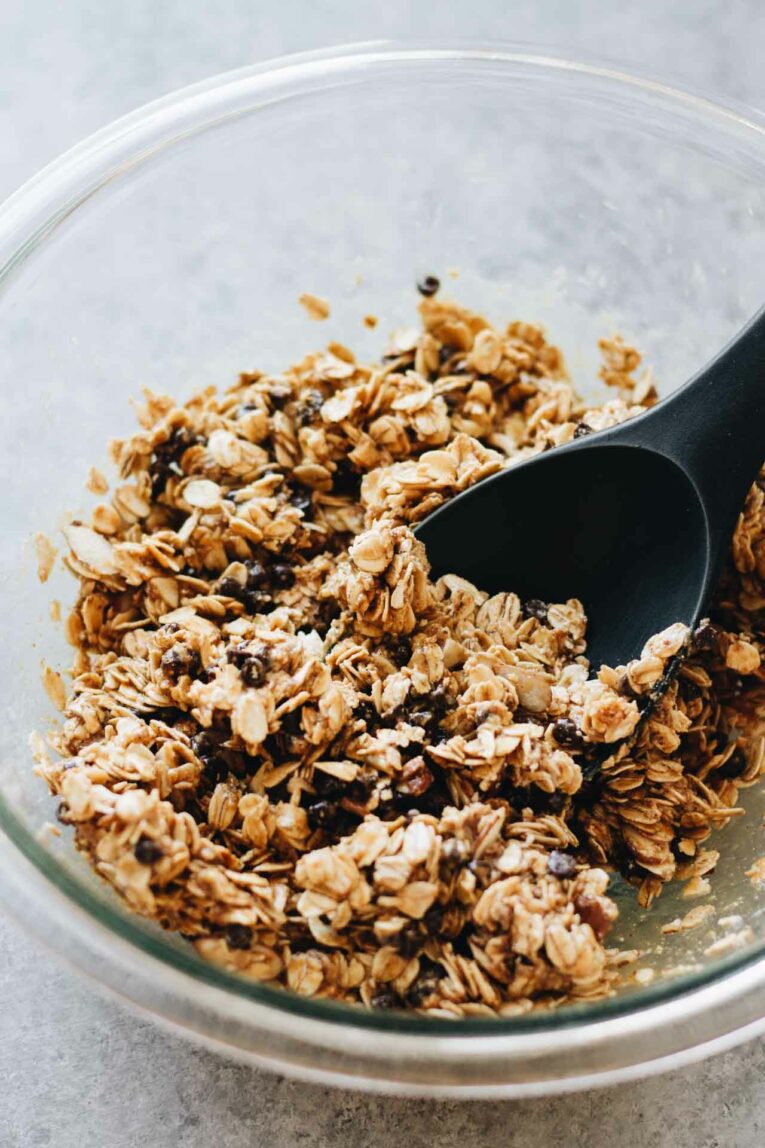 ingredients for The BEST Baked Oatmeal Breakfast Bars in a glass bowl with a spoon.