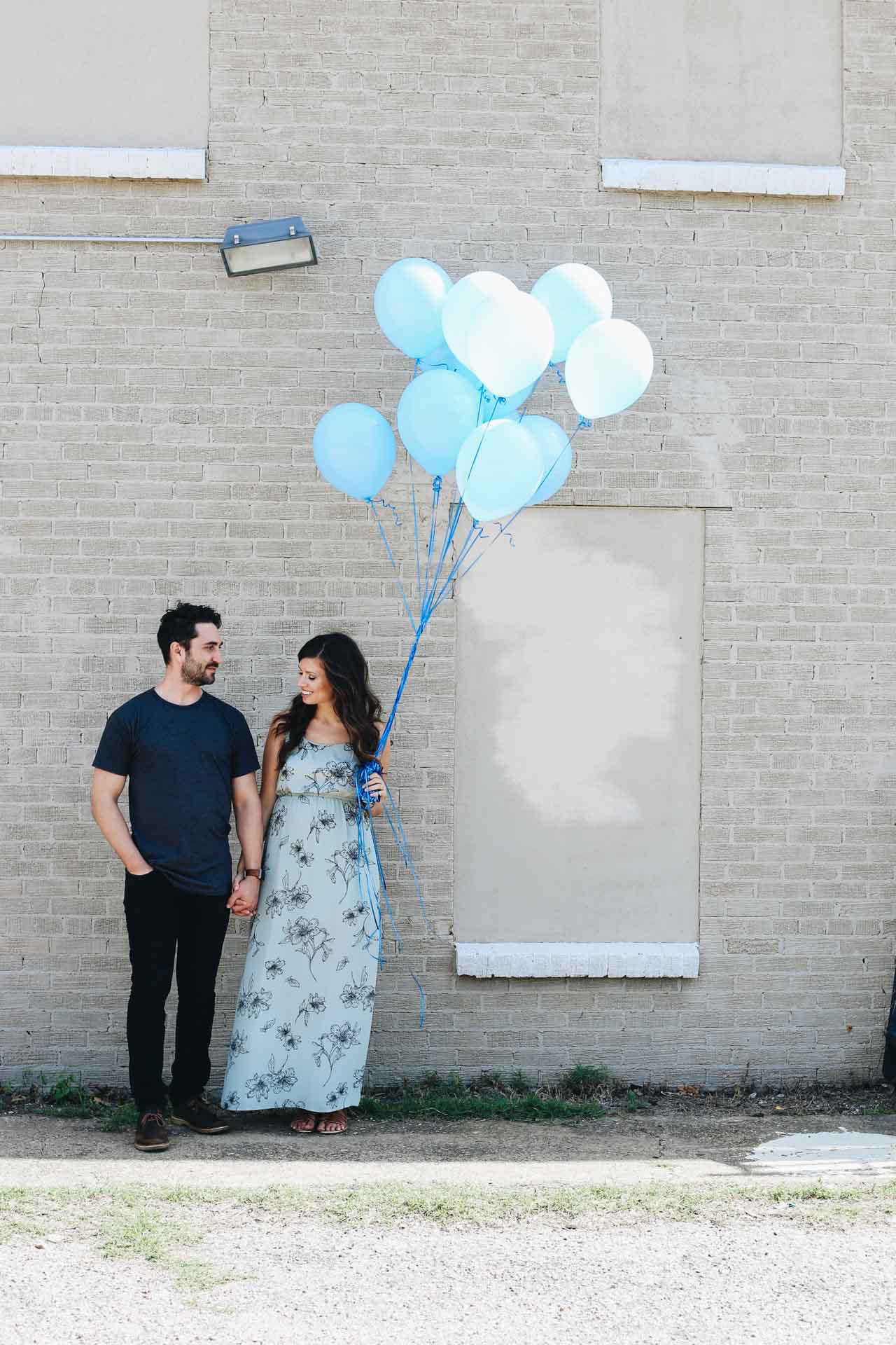 Couple holding blue balloons