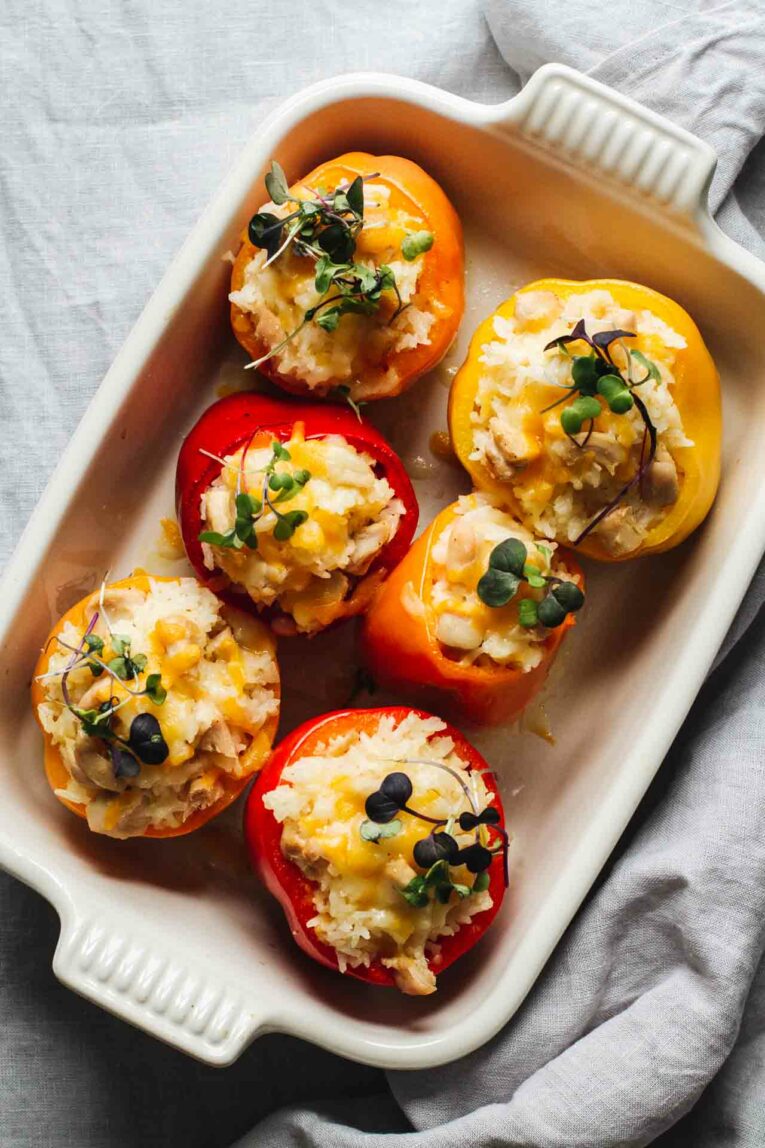 Cheesy Chicken And Rice Stuffed Peppers loaded with long grain rice, shredded cheese, and chicken stuffed into bell peppers and topped with microgreens!