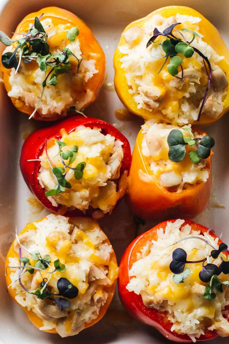 Cheesy Chicken And Rice Stuffed Peppers loaded with long grain rice, shredded cheese, and chicken stuffed into bell peppers and topped with microgreens!