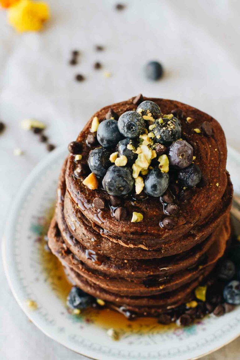 Stack of Chocolate Protein Pancakes topped with blueberries.
