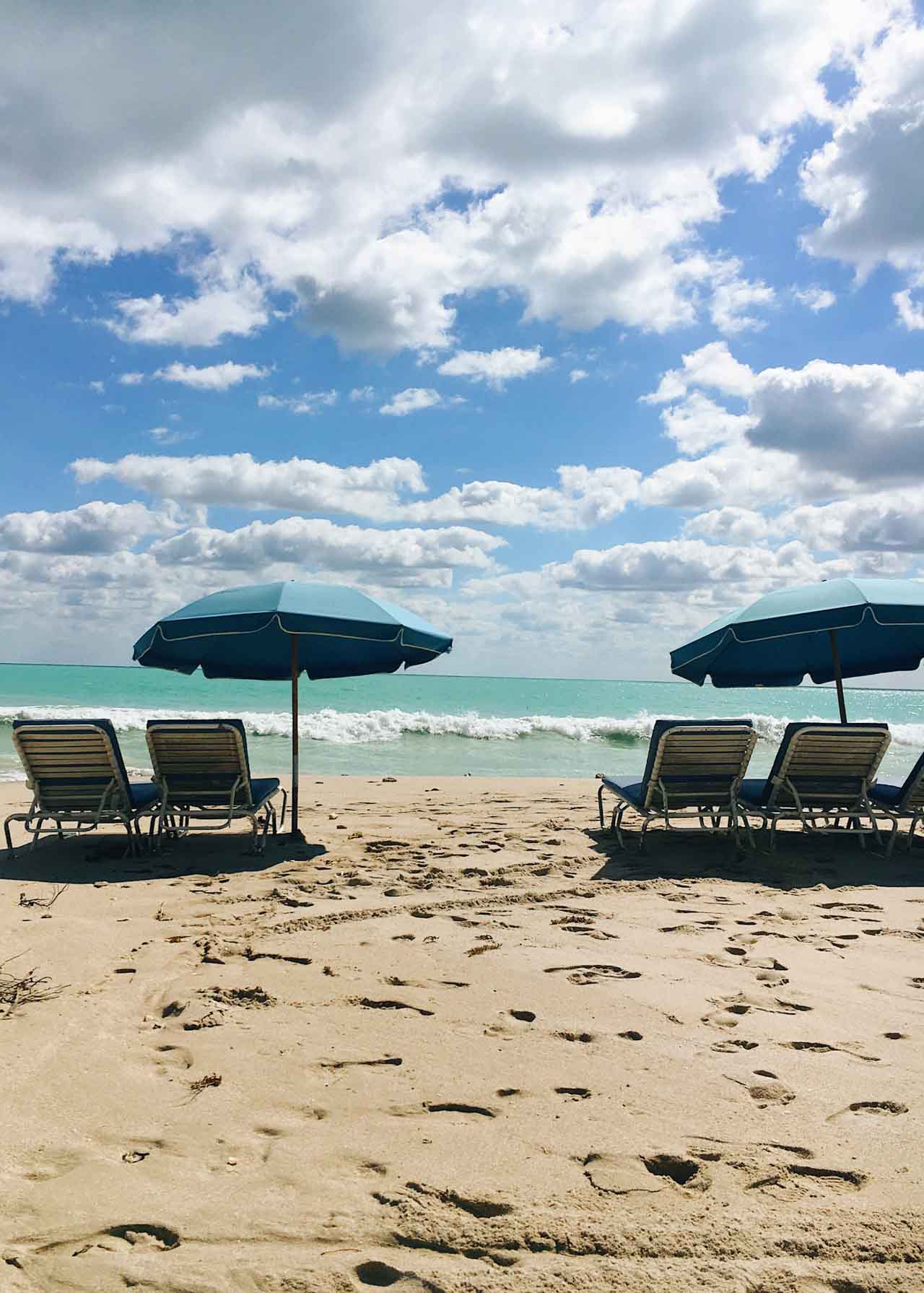 Beach, beach chairs, and umbrella on Miami Beach.