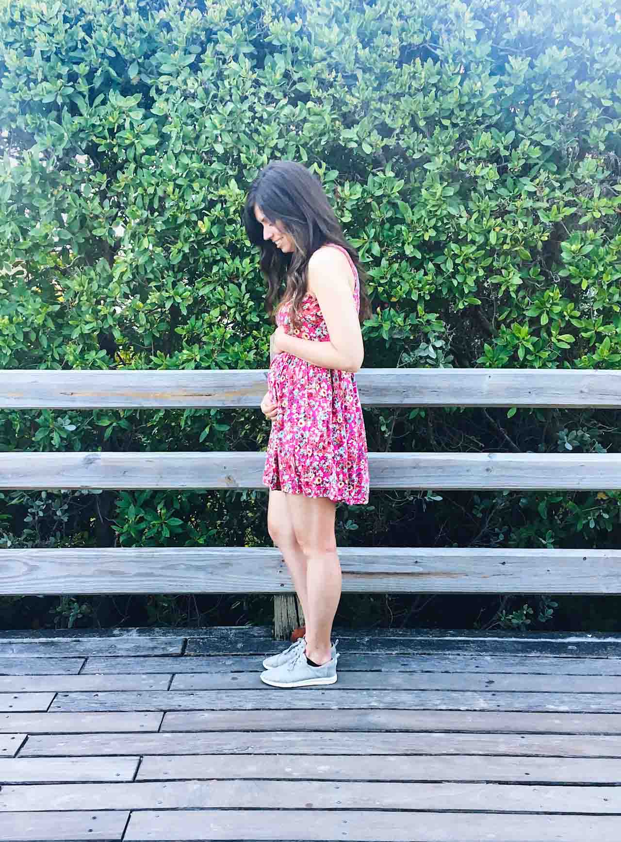 girl showing baby bump at 15 weeks pregnant