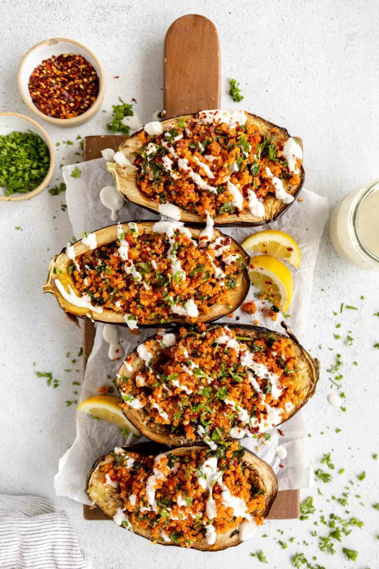Roasted Harissa Eggplant Halves with lentils, yogurt, chicken, turmeric, and fresh parsley!