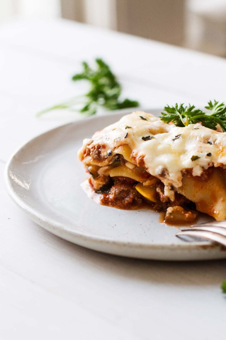 The BEST Easy Healthy Lasagna Recipe slice on a white plate.
