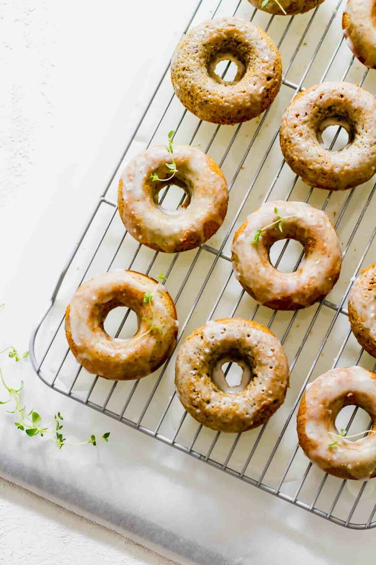 Overhead shot of Lemon Poppy Seed Healthy Baked Donuts on a cooling rack topped with sugar glaze!