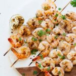 Spicy Grilled Shrimp on a cutting board and white table