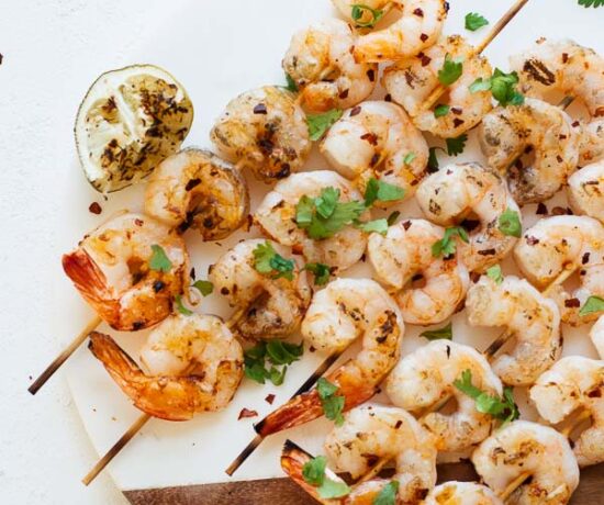 Spicy Grilled Shrimp on a cutting board and white table