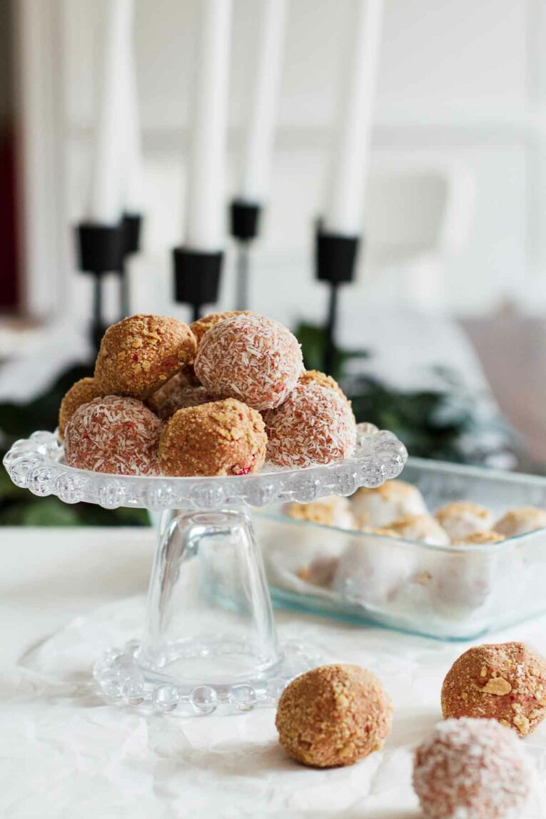 Strawberry Cheesecake No-Bake Energy Bites on a cake stand. These little bites are SO good!