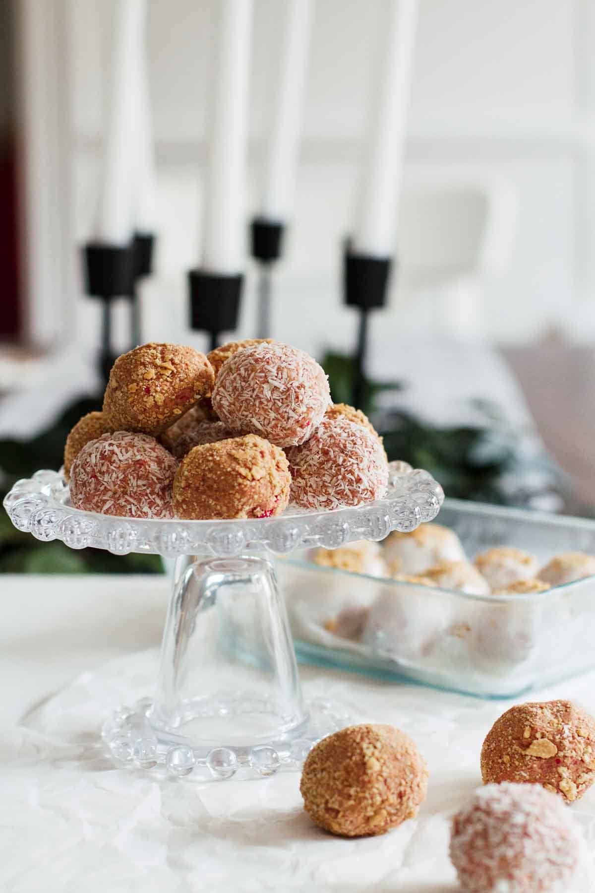 Strawberry Cheesecake No-Bake Energy Bites on a cake stand.