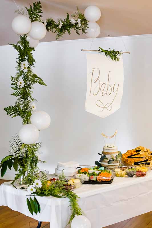 Baby sign over table of food.