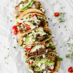 Easy Mexican Barbacoa Tacos by Jar Of Lemons! Corn tortillas topped with slow cooked chuck roast beef, avocado, tomatoes, onions, and feta cheese. So yummy!