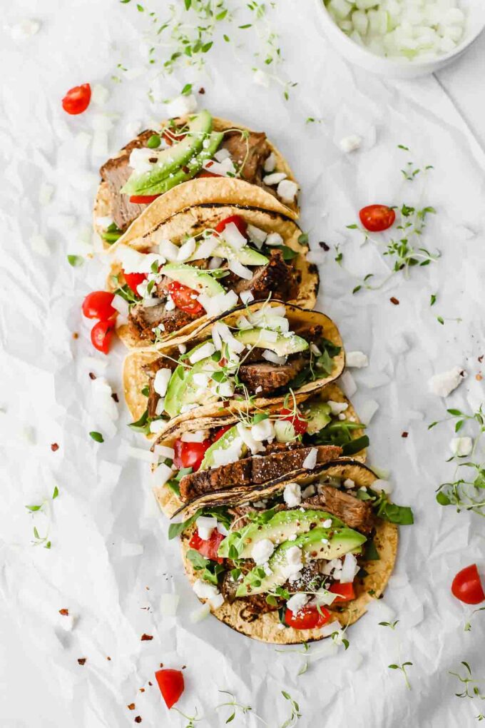 Easy Mexican Barbacoa Tacos by Jar Of Lemons! Corn tortillas topped with slow cooked chuck roast beef, avocado, tomatoes, onions, and feta cheese. So yummy!