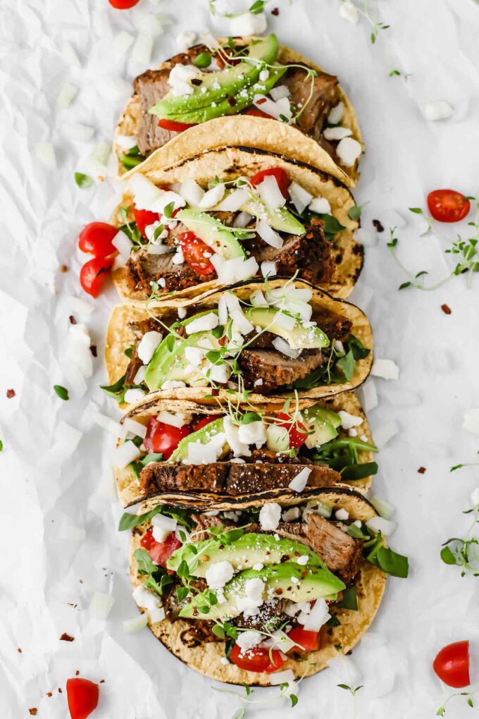 Easy Mexican Barbacoa Tacos by Jar Of Lemons! Corn tortillas topped with slow cooked chuck roast beef, avocado, tomatoes, onions, and feta cheese. So yummy!