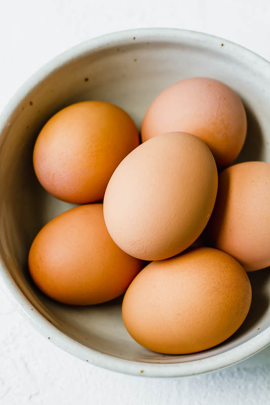 Eggs in a bowl on a white background