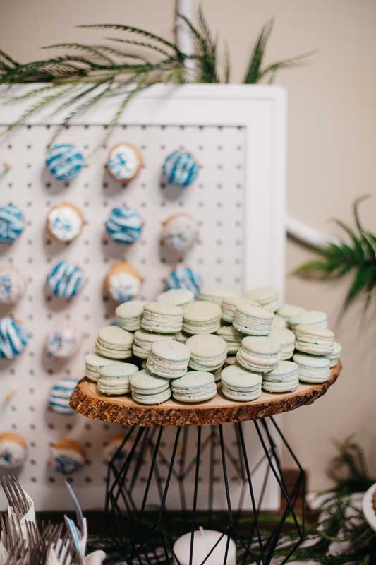 macaroons sitting on a wooden stand.