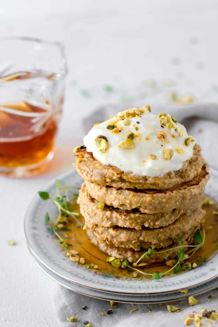 Stack of Simple 3-Ingredient Protein Pancakes served on a white dish.