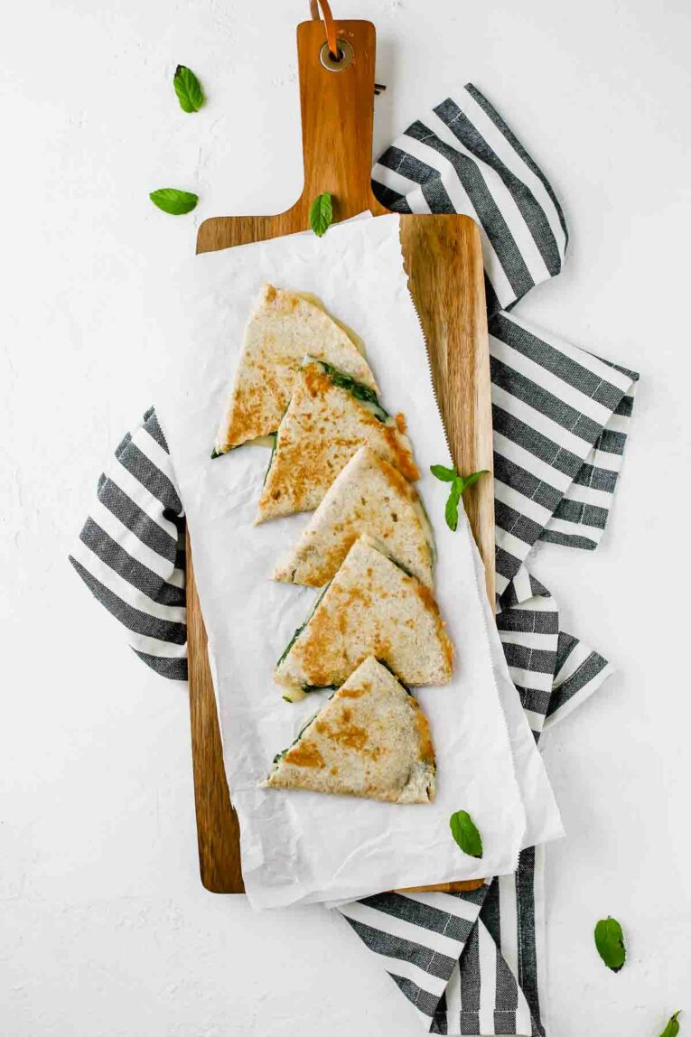 Overhead shot of 5-Minute Spinach Vegetarian Quesadillas on a cutting board.