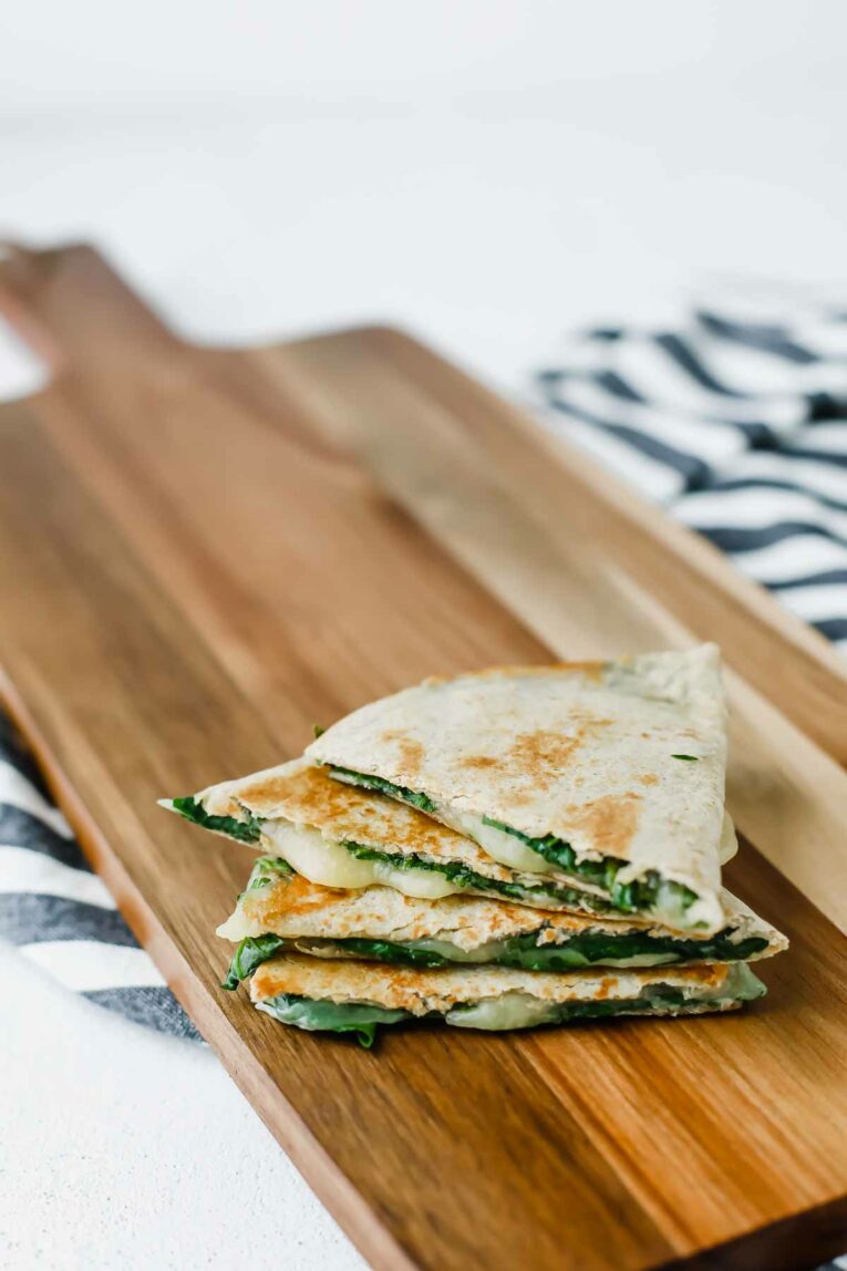 Stack of 4, 5-Minute Spinach Vegetarian Quesadillas on a cutting board.