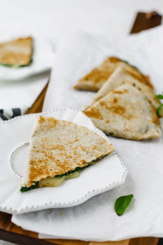 A Slice of 5-Minute Spinach Vegetarian Quesadillas served on a white plate.