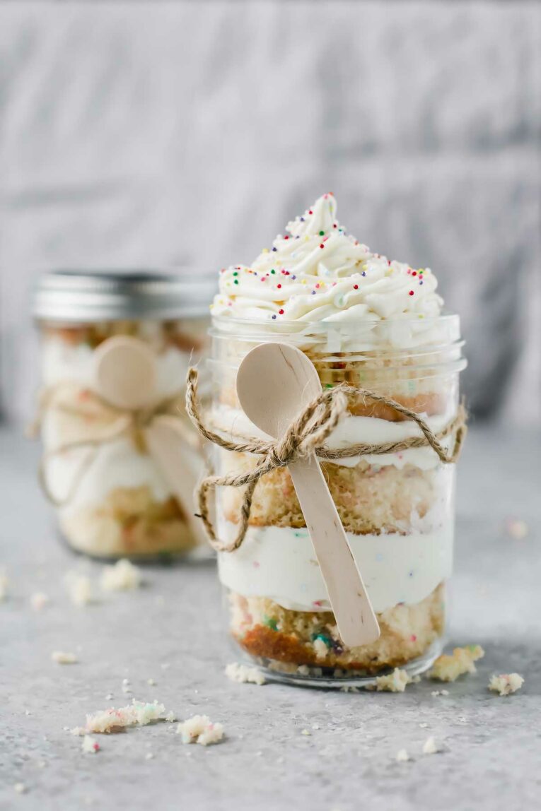 Birthday Cake In A Jar served in a mason jar and wrapped in twine with a spoon.
