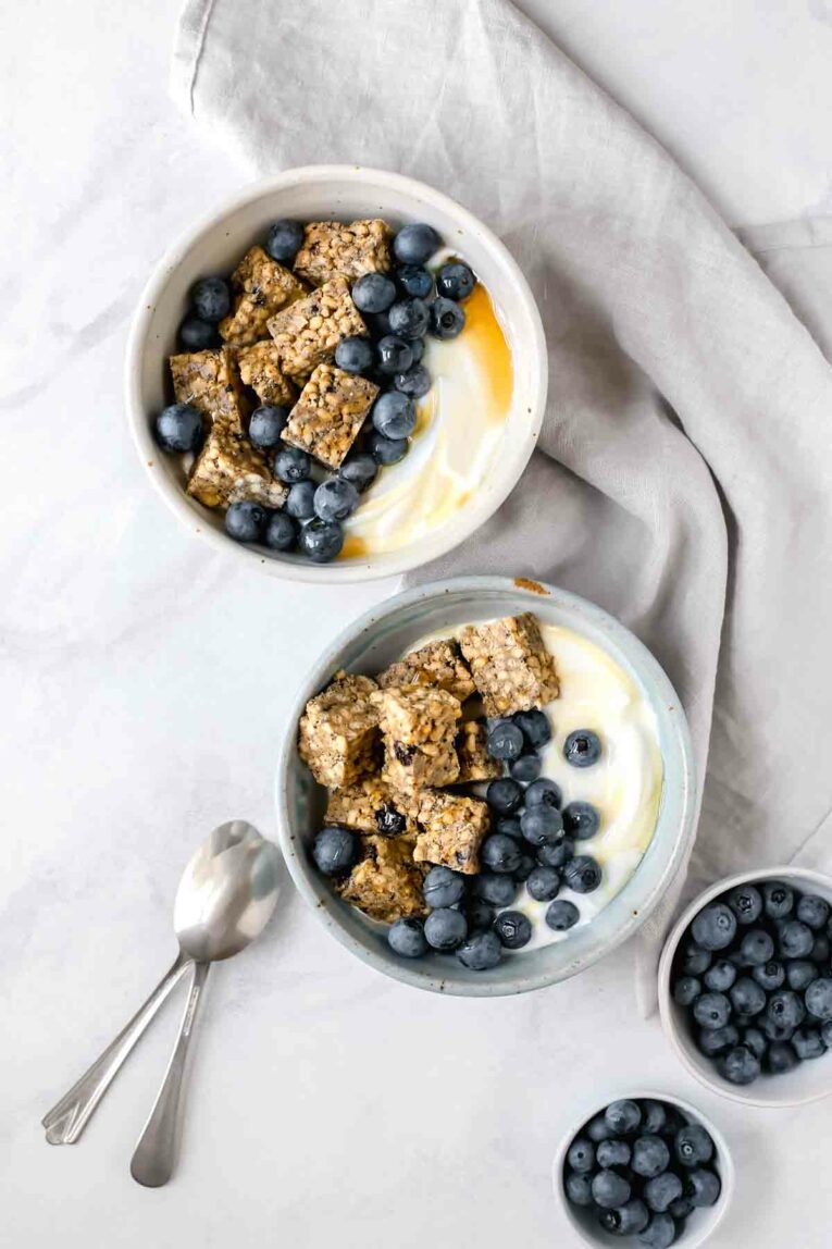 Blueberry & Yogurt Breakfast Bowls served in two bowls next to spoons.