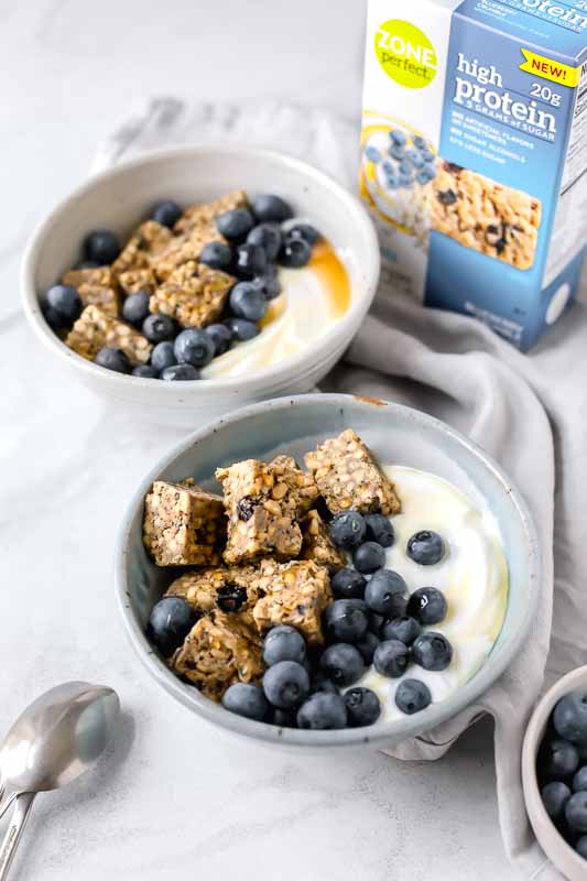 Side shot: Blueberry & Yogurt Breakfast Bowls with ZonePerfect High Protein Bars! Yogurt, blueberries, honey, and bars. So good!