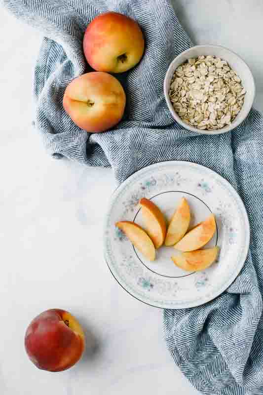 ingredients for  Wholesome Peach Muffins recipe on a dishcloth.