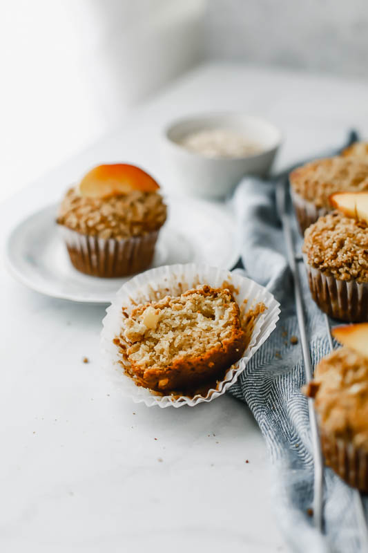 Wholesome Peach Muffin cut in half on the muffin wrapper.