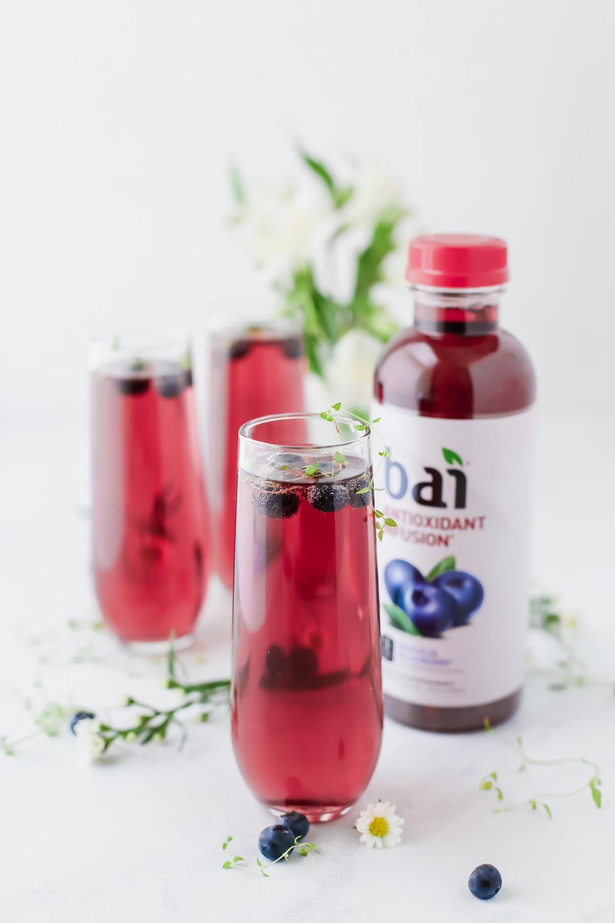Blueberry Thyme Mimosas made with fresh thyme, sparkling water, and Bai blueberry!
