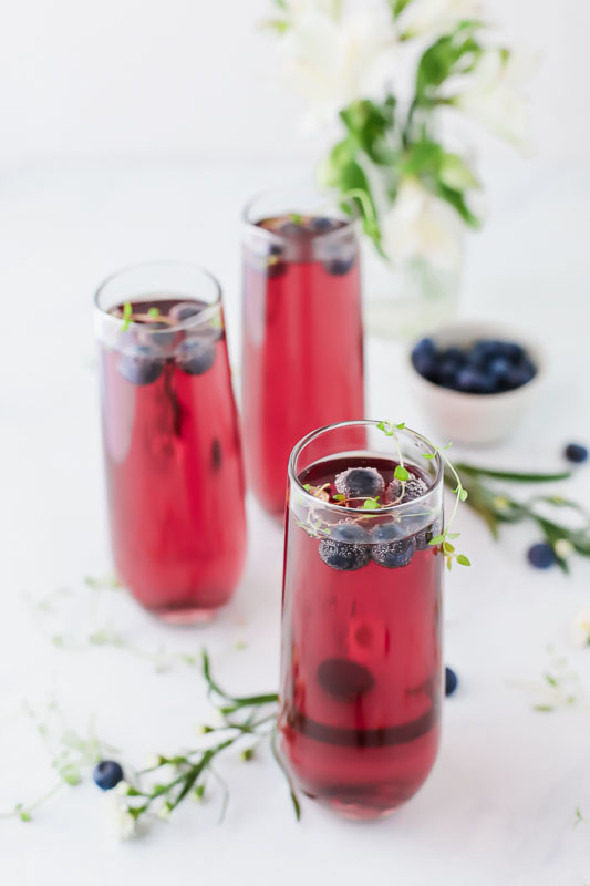  Blueberry Thyme Mimosas served in 3 glasses.